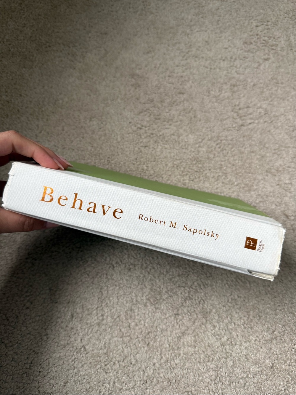 Behave by Robert M. Sapolsky - White & Green Hardcover